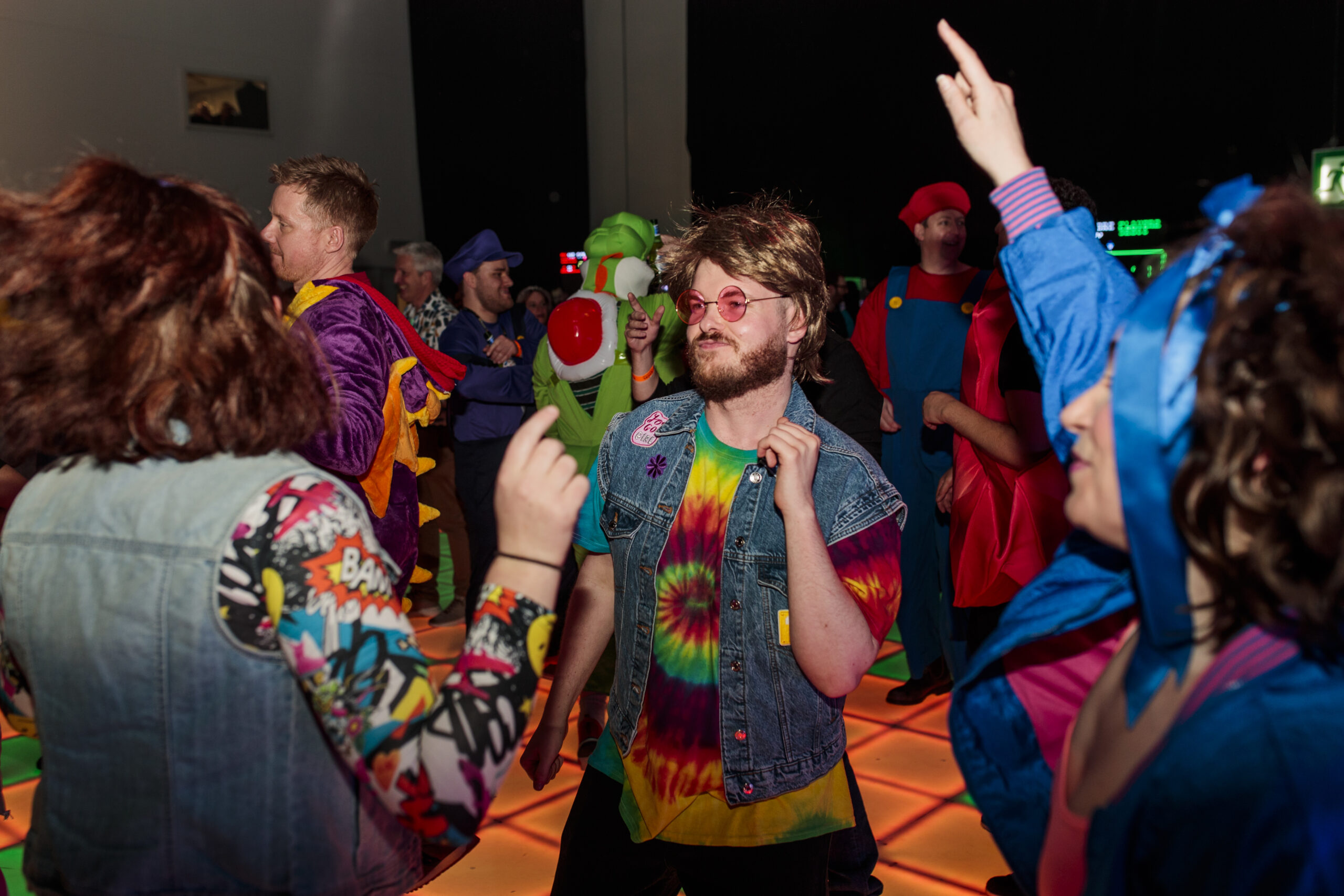 The retro Friday night party dancefloor and people have a good time wearing themed costumes at SQLBits 2022